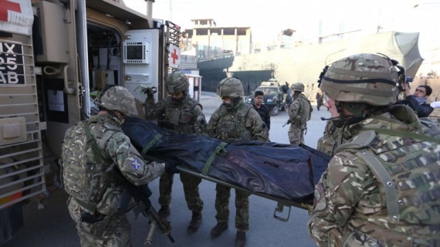 Soldados británicos cargan el cuerpo de una de las víctimas del ataque. (Foto Prensa Libre: AP)