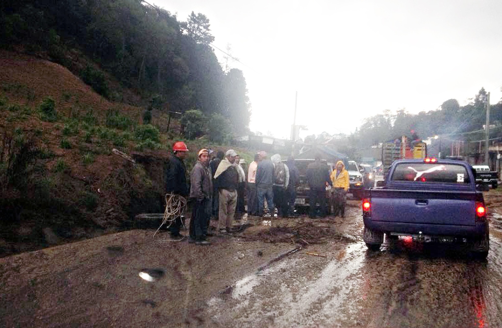 Vecinos de Concepción Chiquirichapa obervan los daños de uno de los vehículos afectados por la correntada. (Foto Prensa Libre: Carlos Ventura)