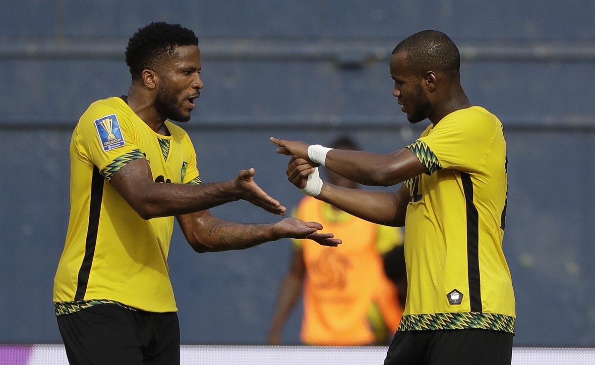 Romario Williams (izquierda), festeja con Jermaine Taylor después del primer gol de Jamaica contra Curazao. (Foto Prensa Libre: AP)