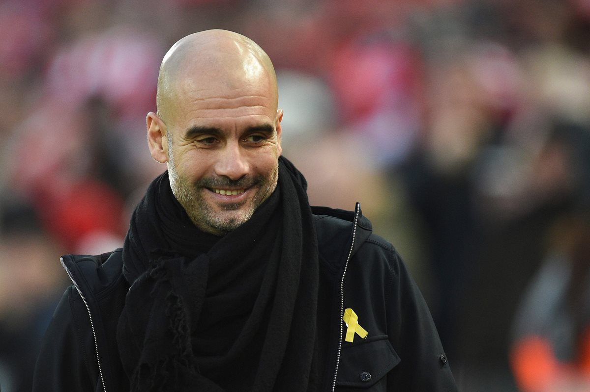 Pep Guardiola llevó un listón amarillo durante el partido entre Manchester City y Liverpool, en Anfield. (Foto Prensa Libre: AFP)