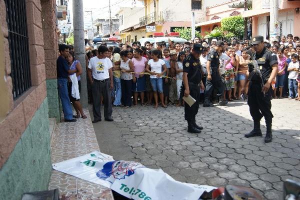 Curiosos observan uno de los cadáveres.