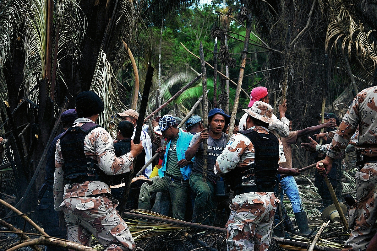 Ocupantes de  sector de área arqueológica El Ceibal, Sayaxché, Petén, se enfrentan a agentes de la Policía que los desalojaron este domingo. (Foto Prensa Libre: Rigoberto Escobar)