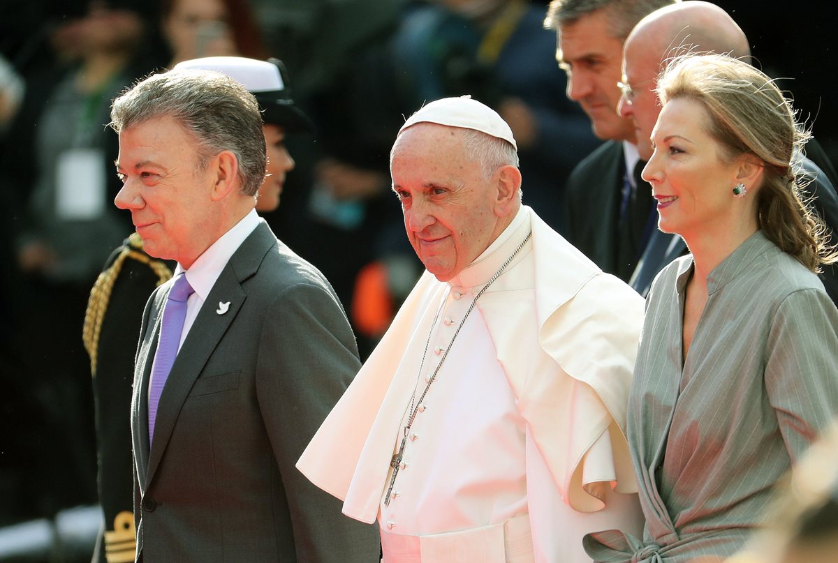 Papa Francisco camina acompañado del presidente de Colombia, Juan Manuel Santos y de la primera dama de la nación, María Clemencia de Santos a su llegada a la base aérea en Colombia. (Foto Prensa Libre: EFE).