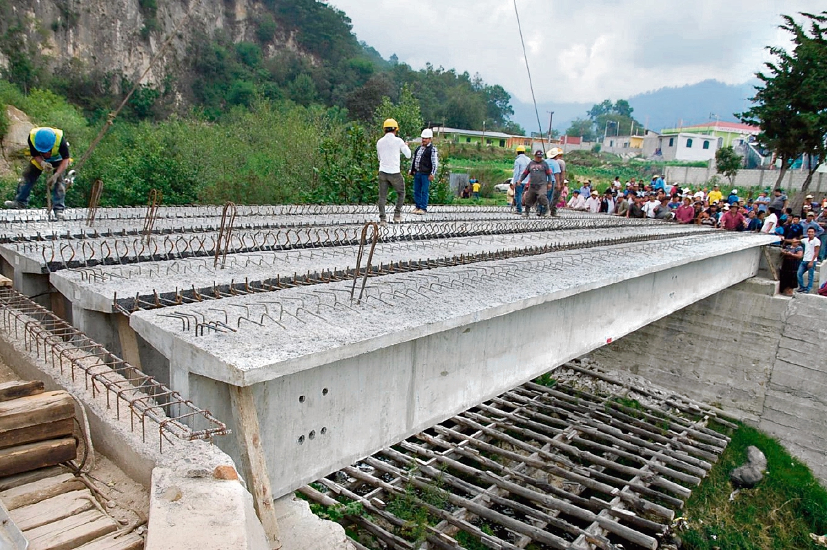 Pobladores de   Sololá observan las cinco vigas reforzadas para la reconstrucción del puente El Molino, destruido en el 2005 por la tormenta Stan. (Foto Prensa Libre: Édgar René Sáenz)