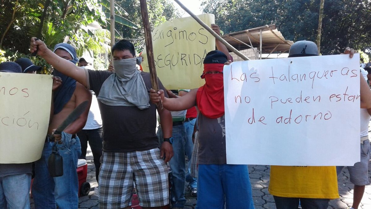 Pilotos de mototaxis en Chicacao muestran pancartas en las que exigen seguridad a las autoridades. (Foto Prensa Libre: Melvin J. Popá)