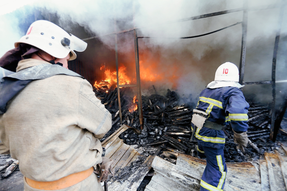 Bomberos extinguen un incendio en un mercado en Donetsk después de los bombardeos entre las fuerzas ucranianas y prorrusos. (Foto prensa Libre:AFP).AFP