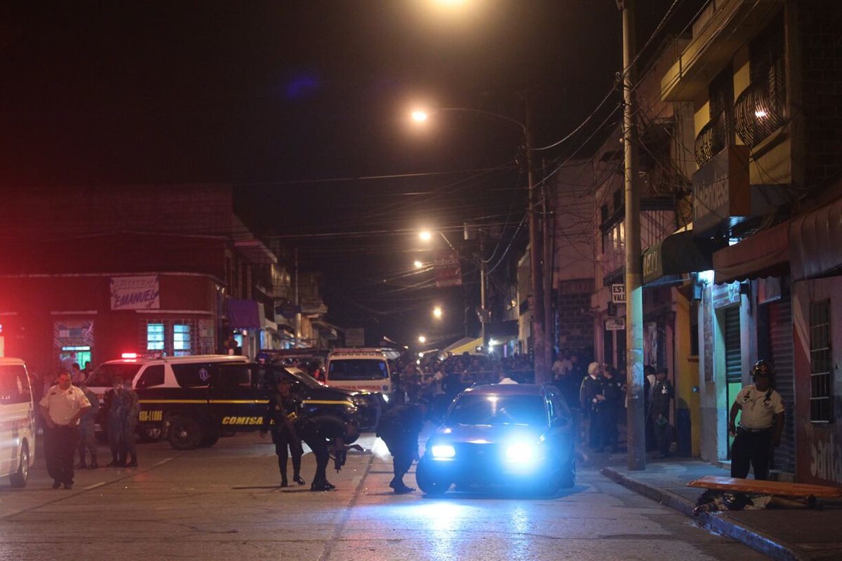 El vehículo, con el motor aún en marcha, es revisado por la PNC, luego del mortal ataque en la zona 3. (Foto Prensa Libre: Álvaro Interiano)
