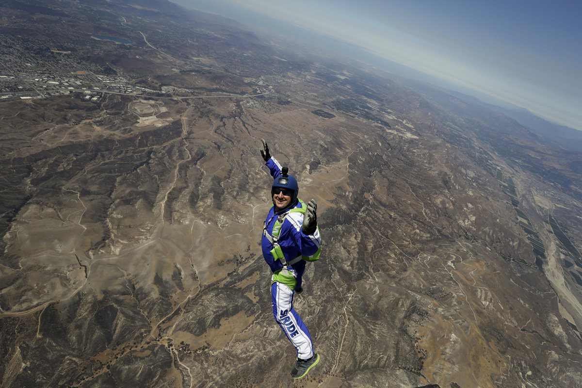 Luke Aikins sonríe mientras cae desde siete mil metros de altura sin paracaídas. (Foto Prensa Libre: AP).