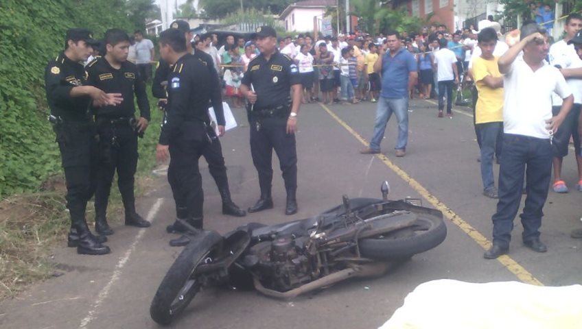 Agentes de la PNC resguardan lugar donde murió un motorista durante un accidente de tránsito en El Asintal. (Foto Prensa Libre: Jorge Tizol)