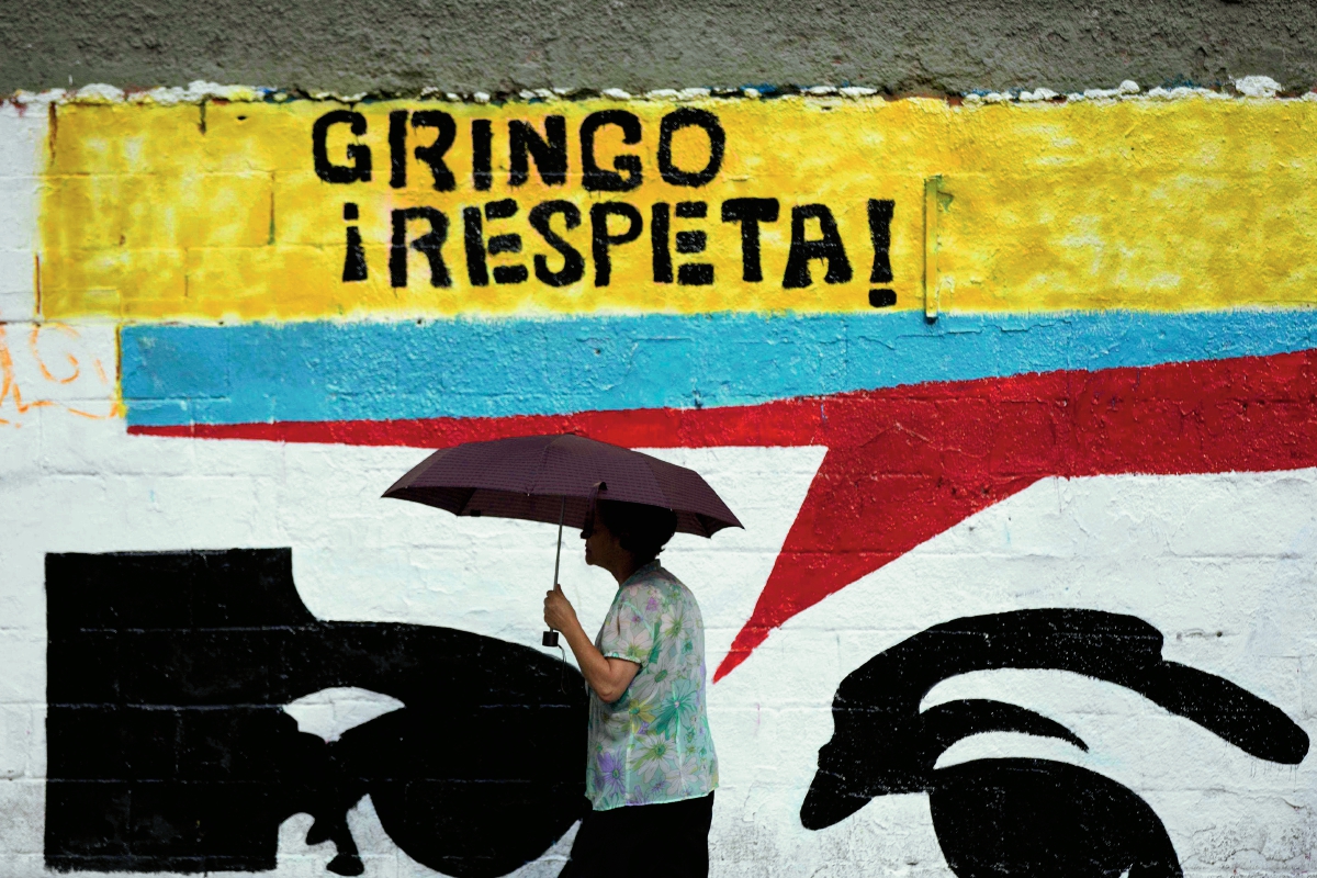 Una mujer pasa frente a un mural en una calle en Caracas, Venezuela, (Foto Prensa Libre :AP)