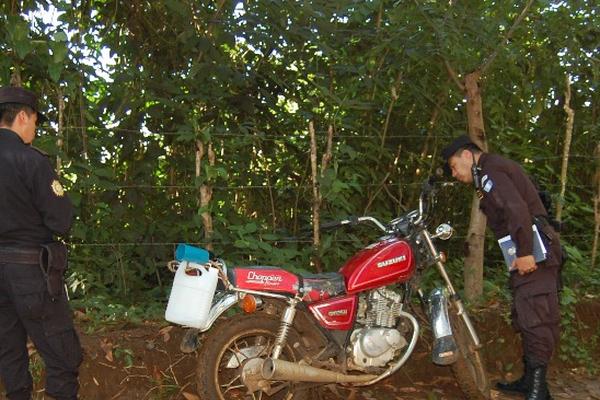 Investigadores inspeccionan la motocicleta en la que viajaba Felipe Otoniel López, quien murió baleado, en El Tumbador. (Foto Prensa Libre: Alexander Coyoy)