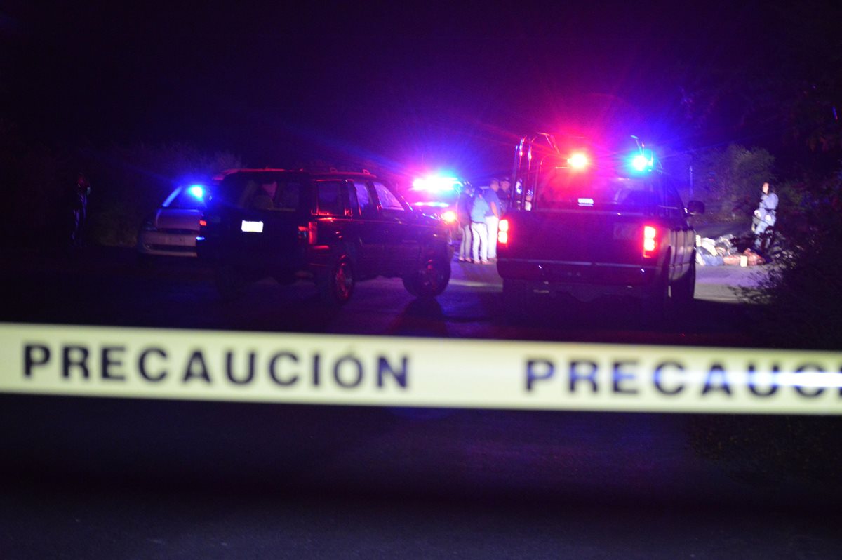 Peritos examinan el sitio donde fueron hallados al menos 8 hombres sin vida y desmembrados en Tixtla, Guerrero. (Foto Prensa Libre: EFE).