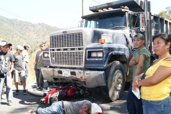 Pobladores observan el cadáver del ayudante que murió luego de accidentarse en su motocicleta con un camión en Baja Verapaz. (Foto Prensa Libre: Carlos Grave)<br _mce_bogus="1"/>
