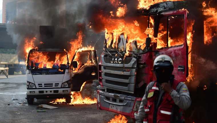 Los camiones incendiados eran del Gobierno, aunque la oposición se deslindó de esos ataques. (Foto Prensa Libre: AFP)