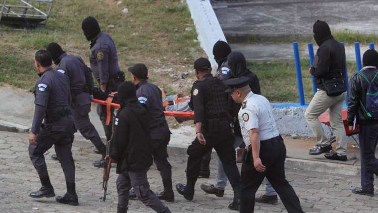 Guardias del Sistema Penitenciario retiran los cadáveres de los cuatro reos muertos hallados en el Preventivo de la zona 18. (Foto Prensa Libre: Estuardo Paredes)
