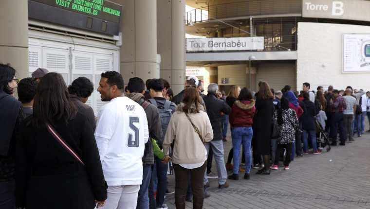Largas colas de aficionados en las inmediaciones del estadio Santiago Bernabéu. (Foto Prensa Libre: EFE)
