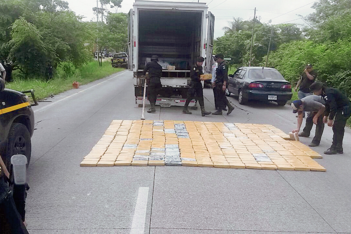 Agentes antinarcóticos contabilizan los paquetes con droga, decomisados en el km 71 de la ruta a Puerto Quetzal, Escuintla. (Foto Prensa Libre: )
