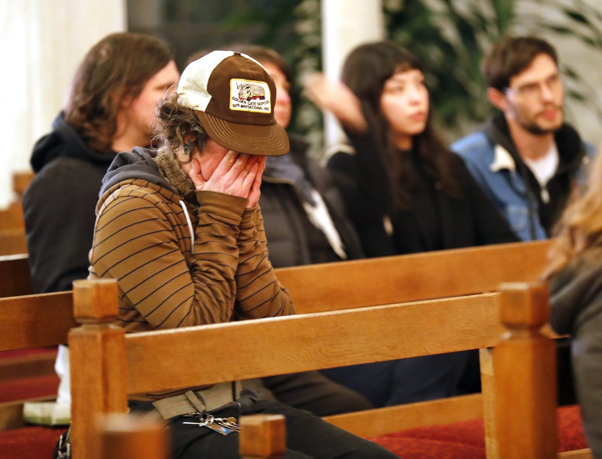 Una mujer, cuyos familiares aún están desaparecidos, llora en una iglesia en Oakland. (Foto Prensa Libre: EFE)