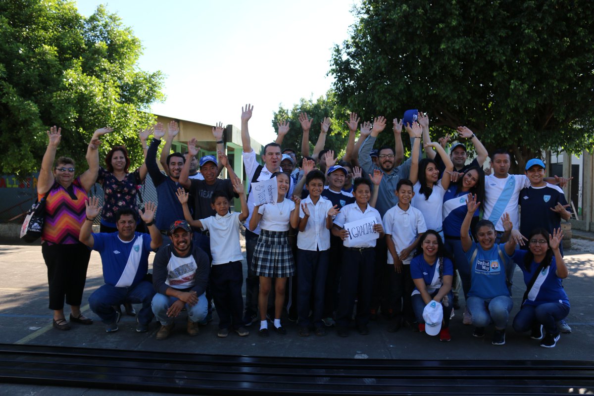 Niños y personal de la Fedefut saludan después de entregar el aula que construyó la Federación Nacional de Futbol en una escuela de Escuintla. (Foto Prensa Libre: Fedefut)