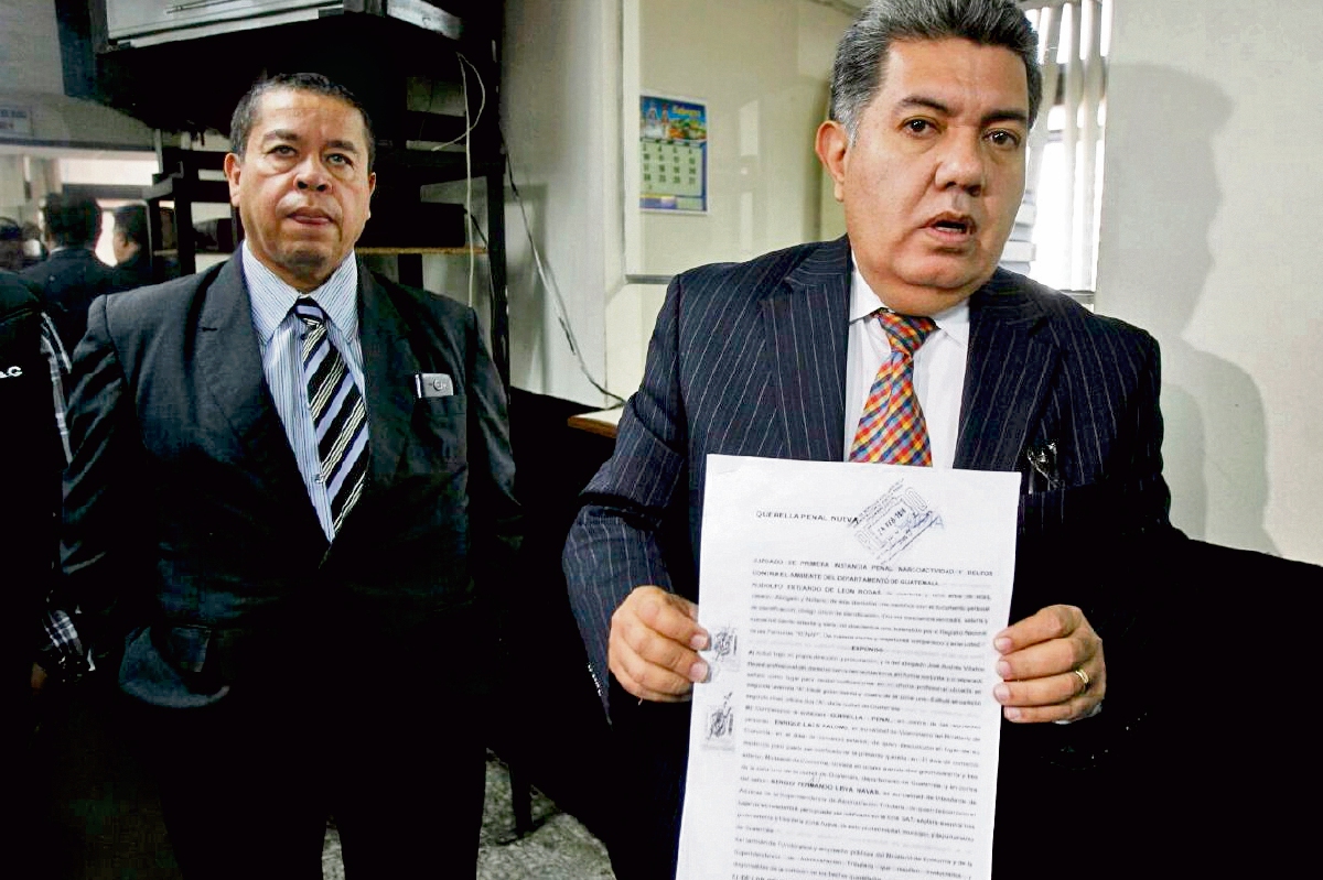 El abogado Rodolfo de León muestra el texto de la demanda que interpuso contra el viceministro de Economía. (Foto Prensa Libre: Paulo Raquec)
