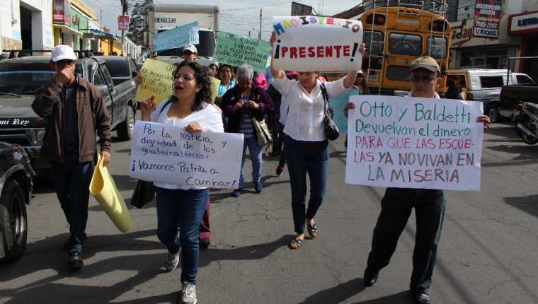 Maestros llevan pancartas en manifestación contra Joviel Acevedo y Otto Pérez Molina,en Xela. (Foto Prensa Libre: María José Longo)