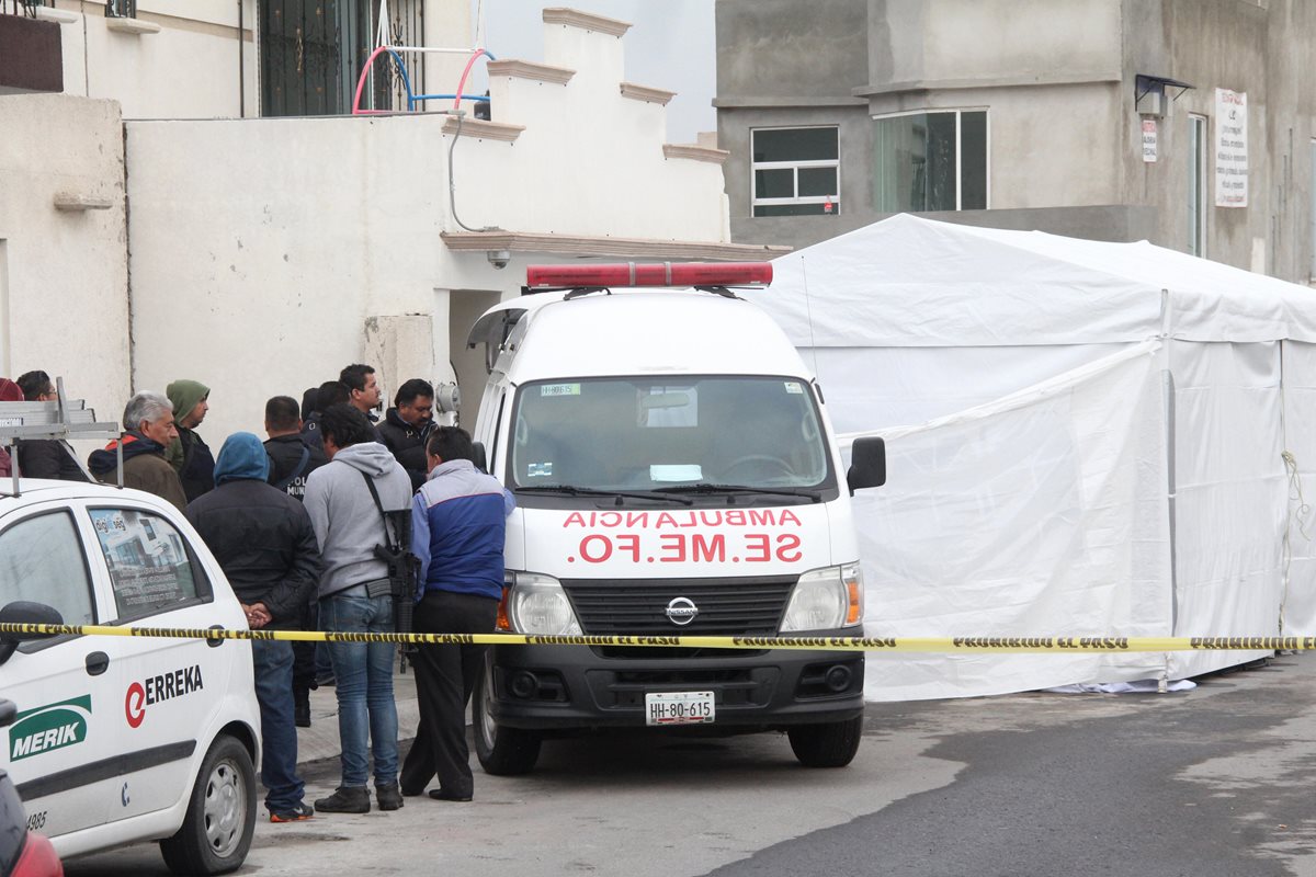 Peritos forenses retiran los cuerpos de las 11 personas asesinadas. (Foto Prensa Libre: EFE)