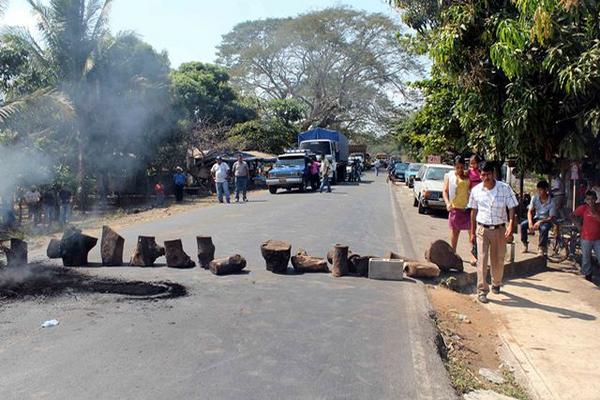 Pobladores de aldea La Guitarra bloquean la carretera que conduce de Retalhuleu hacia Champerico. (Foto Prensa Libre: Rolando Miranda)