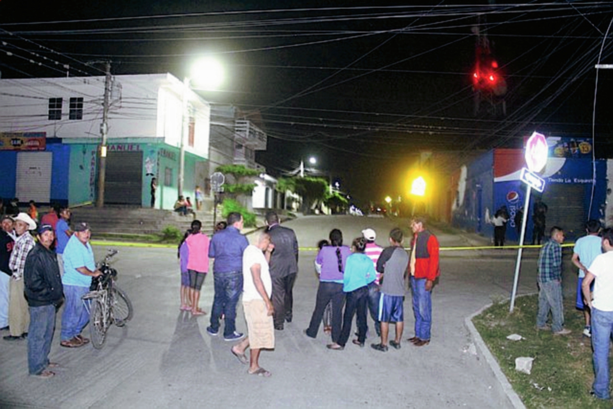 Vecinos observan el trabajo de la Policía Nacional Civil que recoge evidencias del ataque armado. (Foto Prensa Libre: Hugo Oliva).