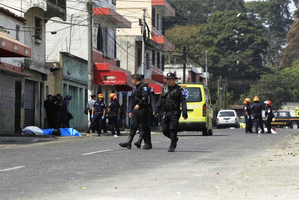 Policías y bomberos revisan el área donde ocurrió el ataque armado esta mañana. (Foto Prensa Libre: Carlos Hernández)
