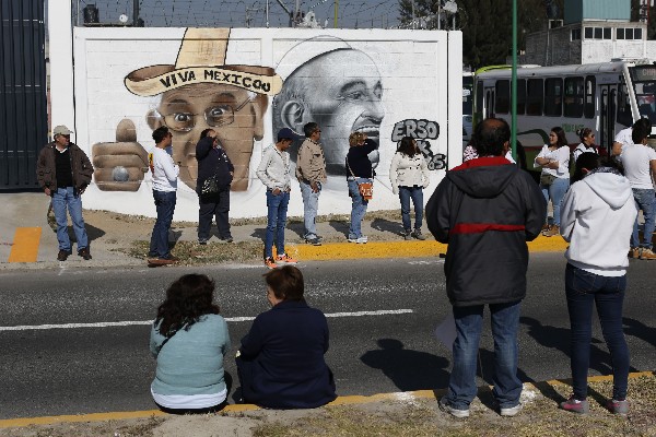 Varios mexicanos <span class="hps">están coloca</span>dos <span class="hps">al lado de un</span> <span class="hps">muro de</span> <span class="hps">murales que representan</span> <span class="hps">al Papa, en la Ciudad de México. (Foto Prensa Libre:AP).</span>