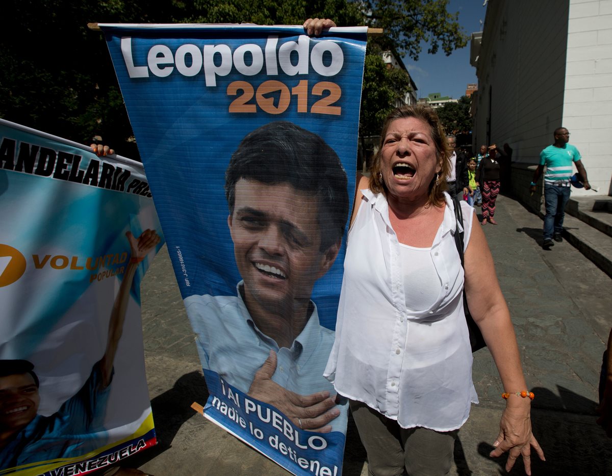 <em>Una simpatizante sostiene una pancarta con la fotografía de Leopoldo López. (Foto Prensa Libre: AP). </em>