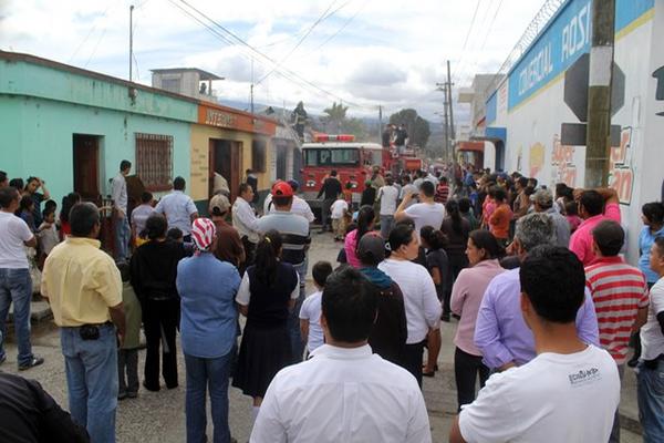Vecinos del barrio Chipilapa, en Jalapa, observan a los Bomberos Voluntarios cuando sofocaban incendio en un negocio. (Foto Prensa Libre: Hugo Oliva)