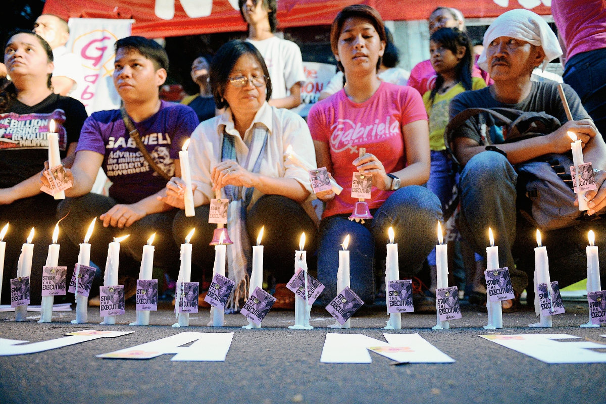 Un grupo de activistas participan en una vigilia ante de la inminente ejecución de la filipina Mary Jane Veloso en Indonesia. (Foto Prensa Libre:AFP)
