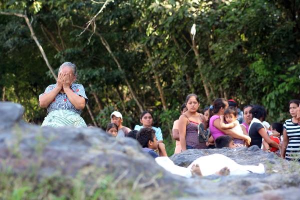 Vecinos del parcelamiento Caballo Blanco observan el cuerpo de Roni Wilfredo Díaz Flores.