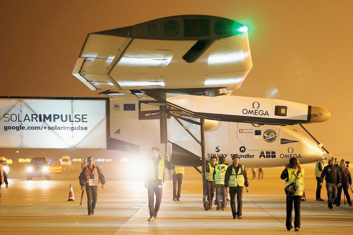 EL personal técnico caminan al lado de la aeronave Solar Impulse 2. (Foto Prensa Libre:AFP)