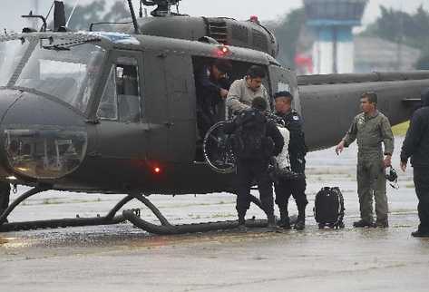 Donald Saúl Villatoro Cano es ayudado por policías para descender del helicóptero.