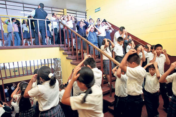 Estudiantes de la escuela Betancourt, zona 1, salen del establecimiento, en un simulacro de terremoto que organizaron, coordinados por sus maestros.