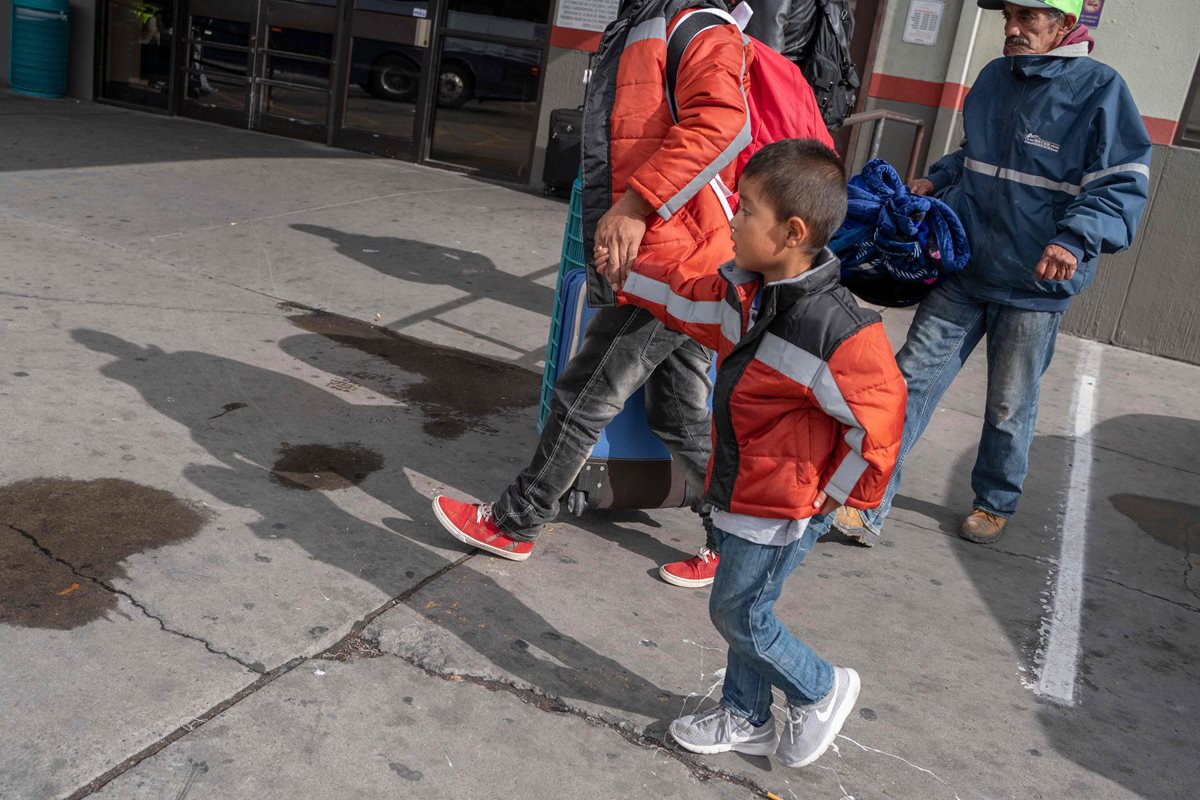 Algunos migrantes del grupo que fue abandonado en Texas, entre ellos varios niños, buscan a dónde ir. (Foto Prensa Libre: AFP)