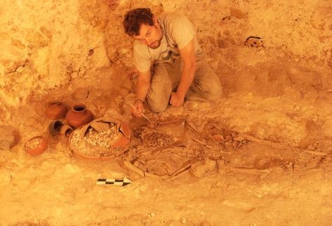 Uno de los técnicos del equipo de Francisco Estrada-Belli   limpia  y clasifica los restos humanos y las piezas de cerámica, entre estas un incensario, encontrados en  Holmul, Petén.