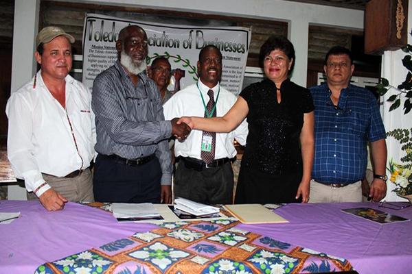 El empresario Harold Geovani Peralta Carrero -a la derecha con camisa azul- durante la firma de un convenio comercial. (Foto Prensa Libre)