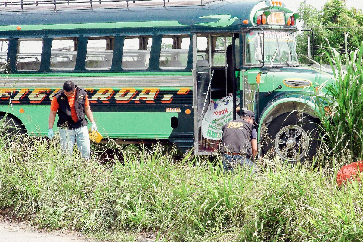 El autobús  se salió de la cinta asfáltica cuando el piloto fue abatido a balazos, en Cuyotenango, Suchitepéquez. (Foto Prensa Libre: Omar Méndez)