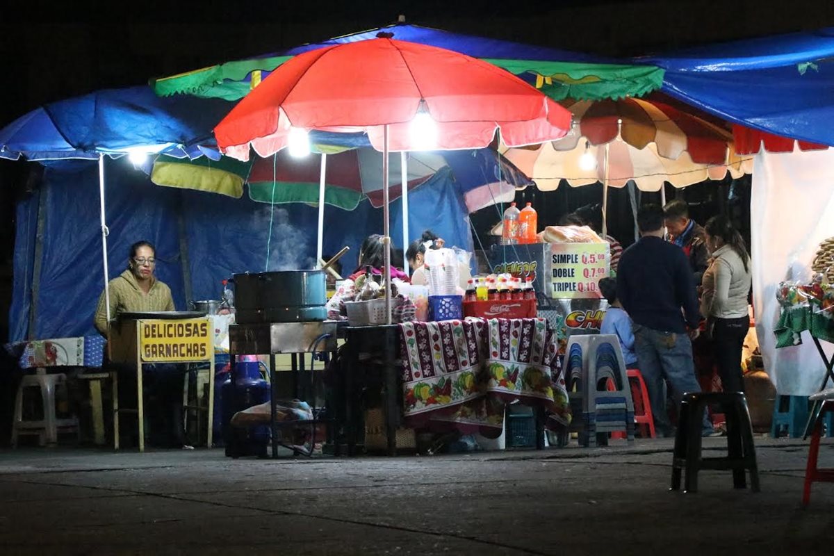 Venta de comida en el mercado La Democracia, zona 3, donde utilizan más de cuatro focos. (Foto Prensa Libre: María José Longo)