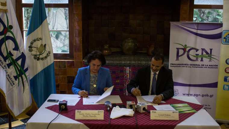 Annabella Morfín, jefa de la PGN, y Leonel Dubón, del Refugio de la Niñez, firman el convenio de cooperación. (Foto Prensa Libre: PGN)