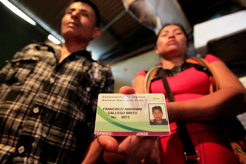 Los padres de Francisco Gallego muestran el carné con la fotografía de su hijo, el cual le permitía el ingreso al relleno sanitario de la zona 3 de la Ciudad de Guatemala. (Foto Prensa Libre: Edwin Bercián)