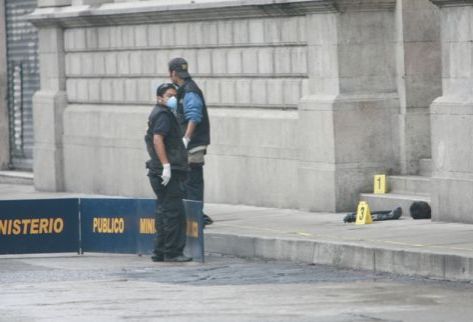 Técnicos del Ministerio Público buscan evidencias alrededor de la cabeza humana hallada en una bolsa negra con el rostro hacia el interior del Congreso de la República. (Foto Prensa Libre: Carlos Sebastián)