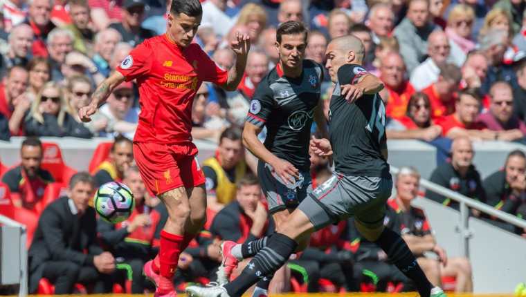Philippe Coutinho disputa el balón con Oriol Romeu durante un juego de la Premier League entre el Liverpool y Southampton. (Foto Prensa Libre: EFE)