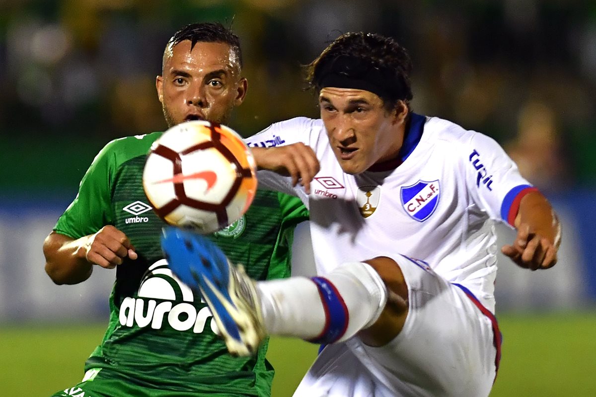 Guilherme del Chapecoense presiona a Alfonso Espino en el duelo del miércoles de la Copa Libertadores. (Foto Prensa Libre: AFP)