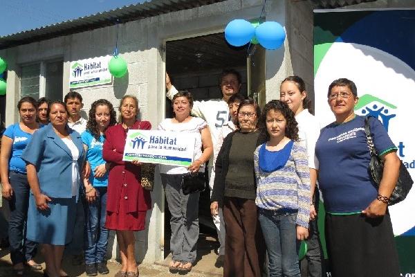 Manuel  Arana y Lisbeth Orozco, junto a familiares y representantes de Hábitat, en su nueva vivienda.