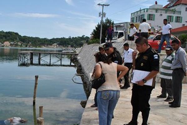 Fiscales del MP, policías y socorristas observan el cuerpo de una persona que se ahogó en el lago Petén Itzá. (Foto Prensa Libre. Rigoberto Escobar)