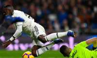 Real Madrid's Brazilian forward Vinicius Junior falls down during the Spanish League football match between Real Madrid CF and Real Sociedad at the Santiago Bernabeu stadium in Madrid on January 6, 2019. (Photo by GABRIEL BOUYS / AFP)
